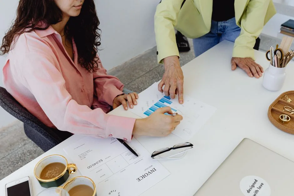 Business professionals collaborating on financial data analysis in a modern office setting.